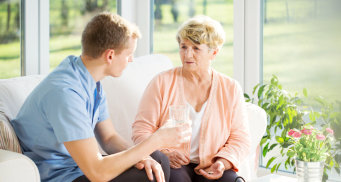 senior woman talking to her caregiver