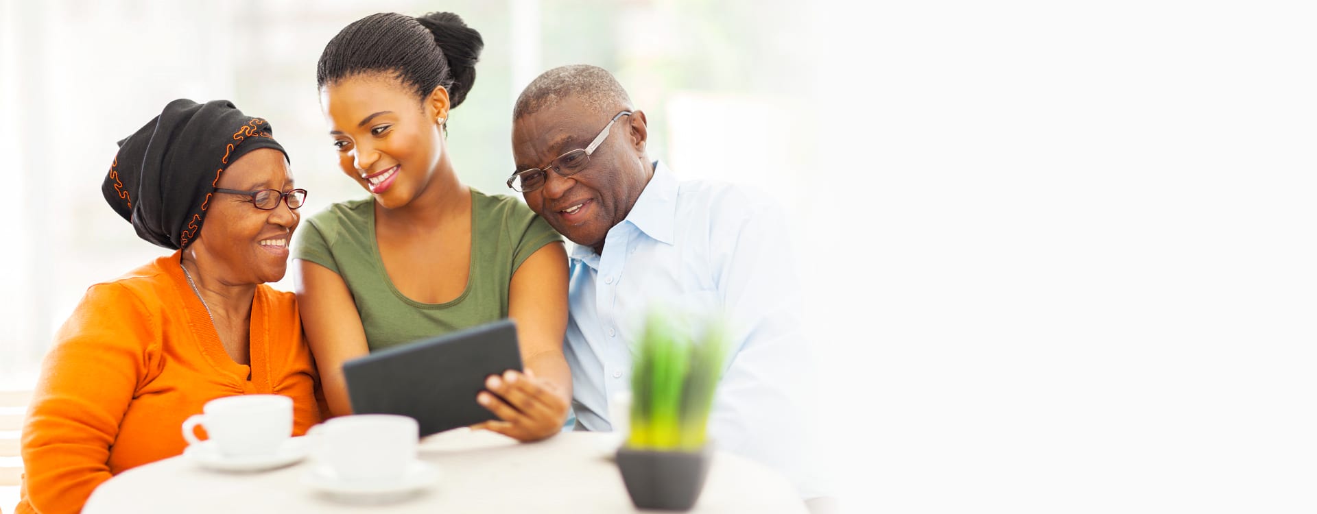Cheerful african family at home using tablet